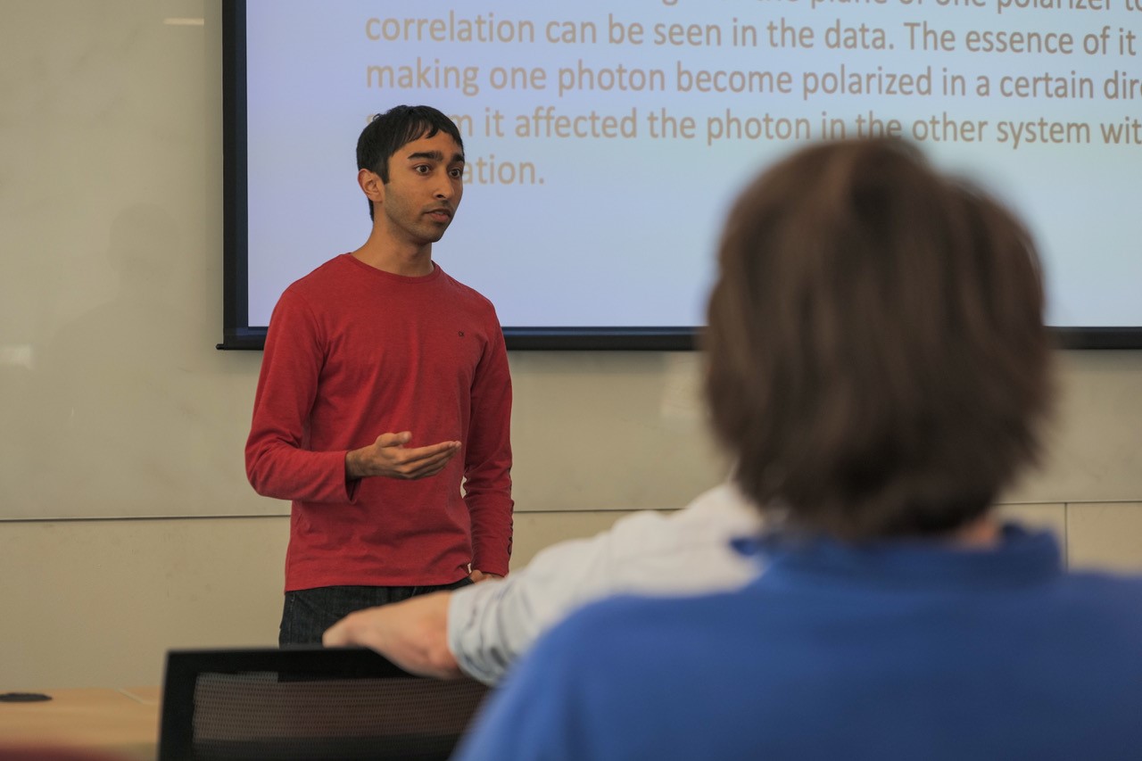 Swapneal Jain talks to his classmates about detecting photons in quantum entanglement.