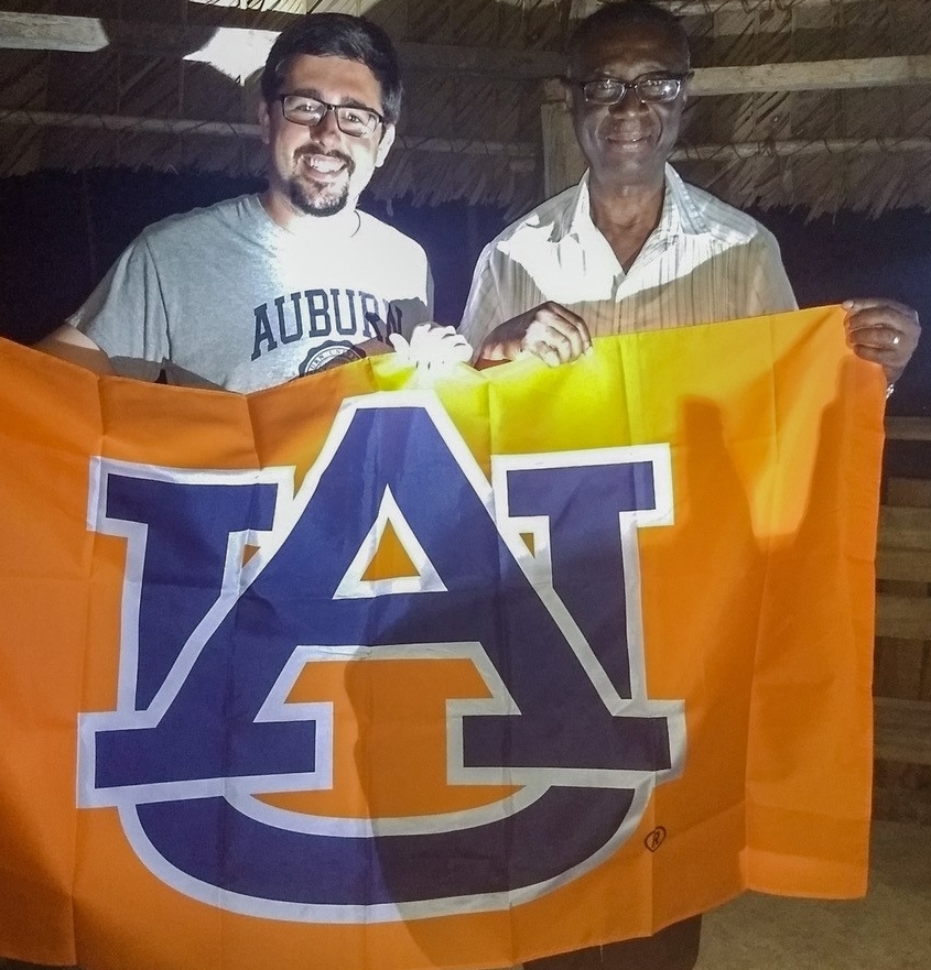 Adam Brasher and a local government official from Guyana, a country on South America’s North Atlantic coast, proudly hold an Auburn flag together. The REO or governor of Region 2 asked Brasher “Where’d you get that jersey?” when he met him. He graduated from Auburn in 1988, and returned to Guyana and became a government official. He welcome Brasher to the village and reminded him that no matter where he goes that he will always be part of the Auburn family. 