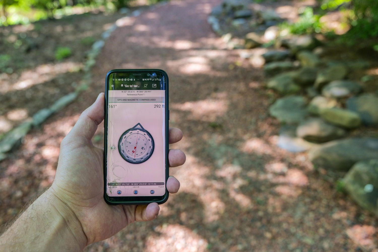 phone with a compass pointing toward the geocache