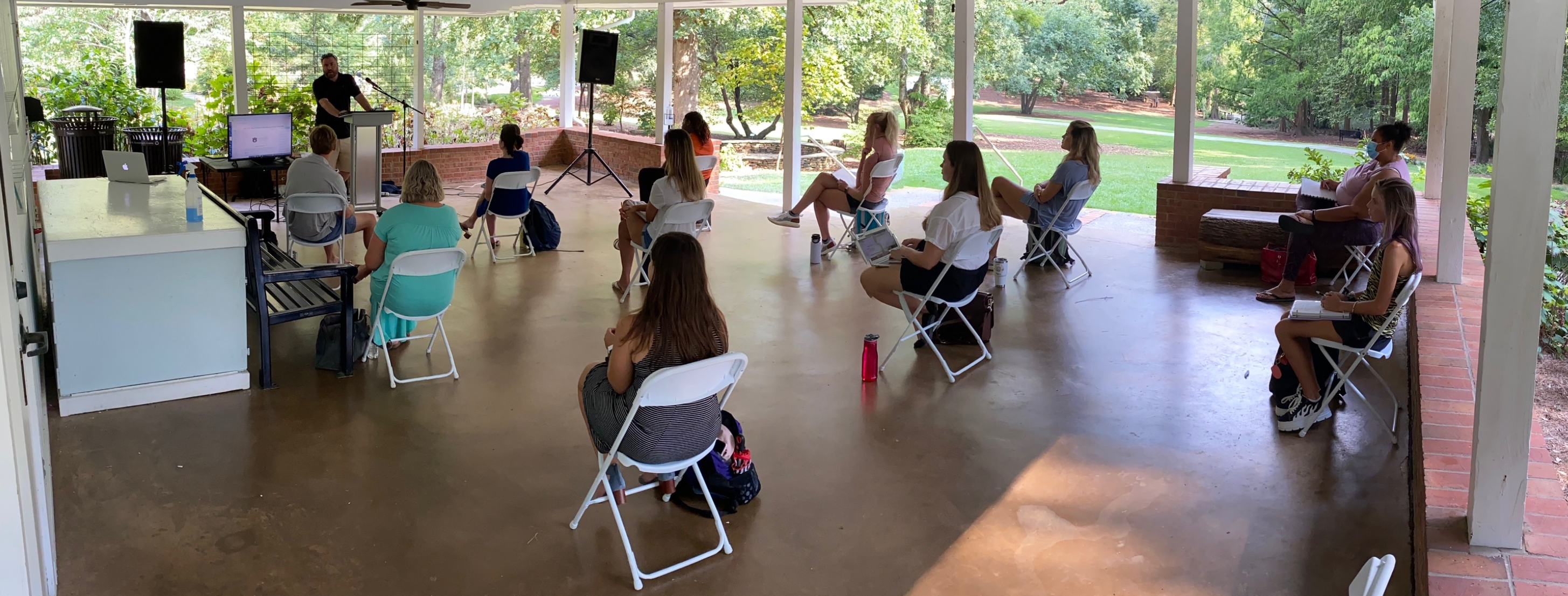 Students listening to David Marshall teaching his class at the Davis Arboretum. 