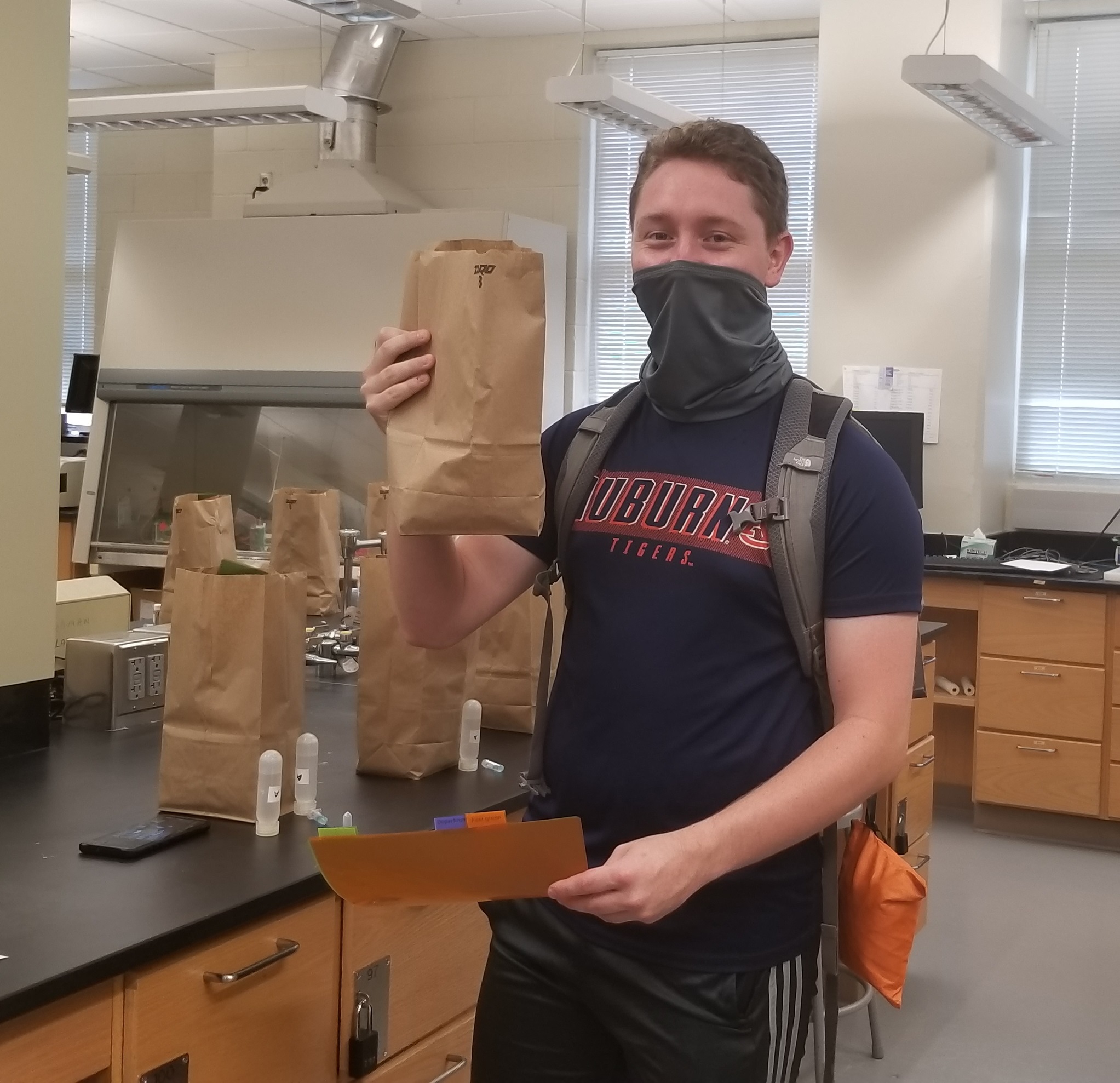 Dylan Blevins picks-up his at-home biochemistry labs kit.