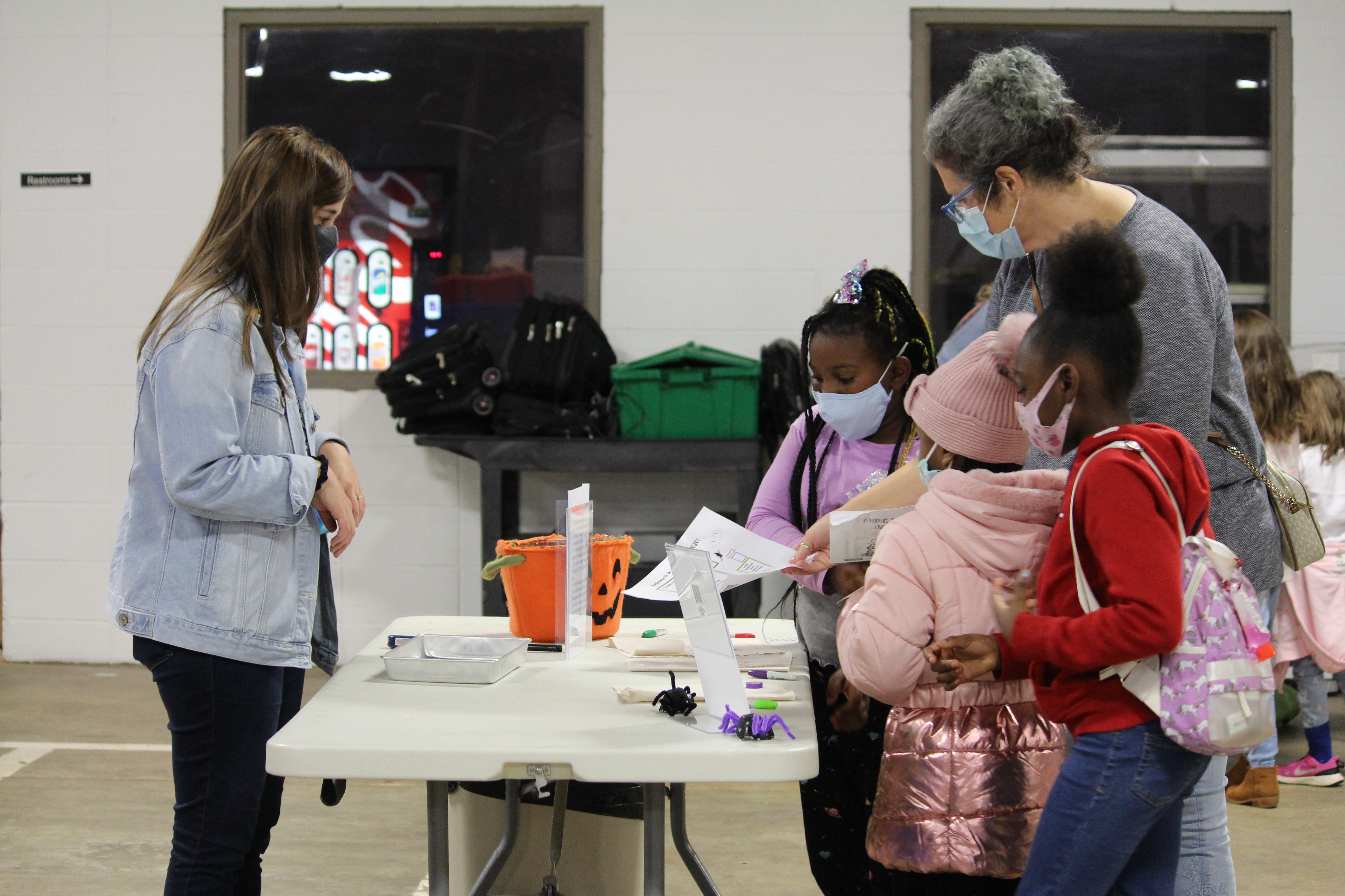 Children at table with volunteer for Junior Mad Scientists event