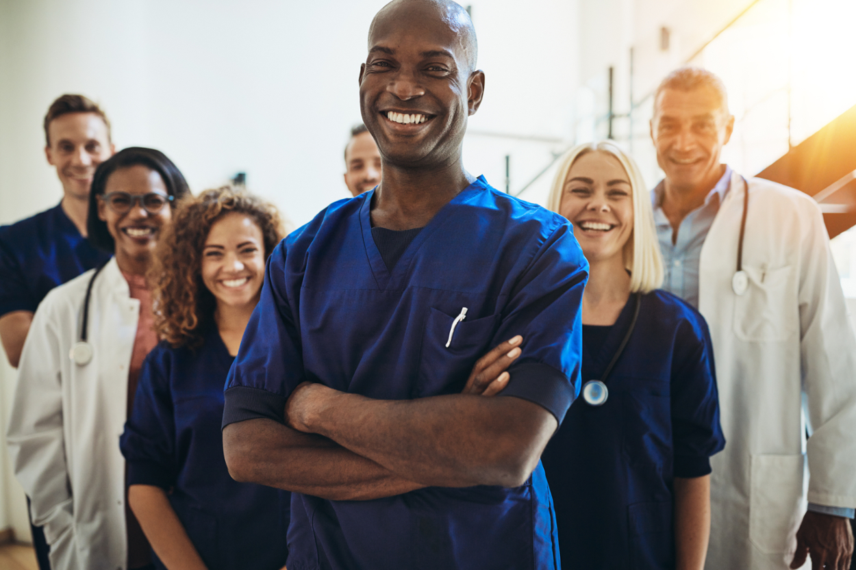 Stock photo of African-American doctor in front of a racially diverse group of medical professionals