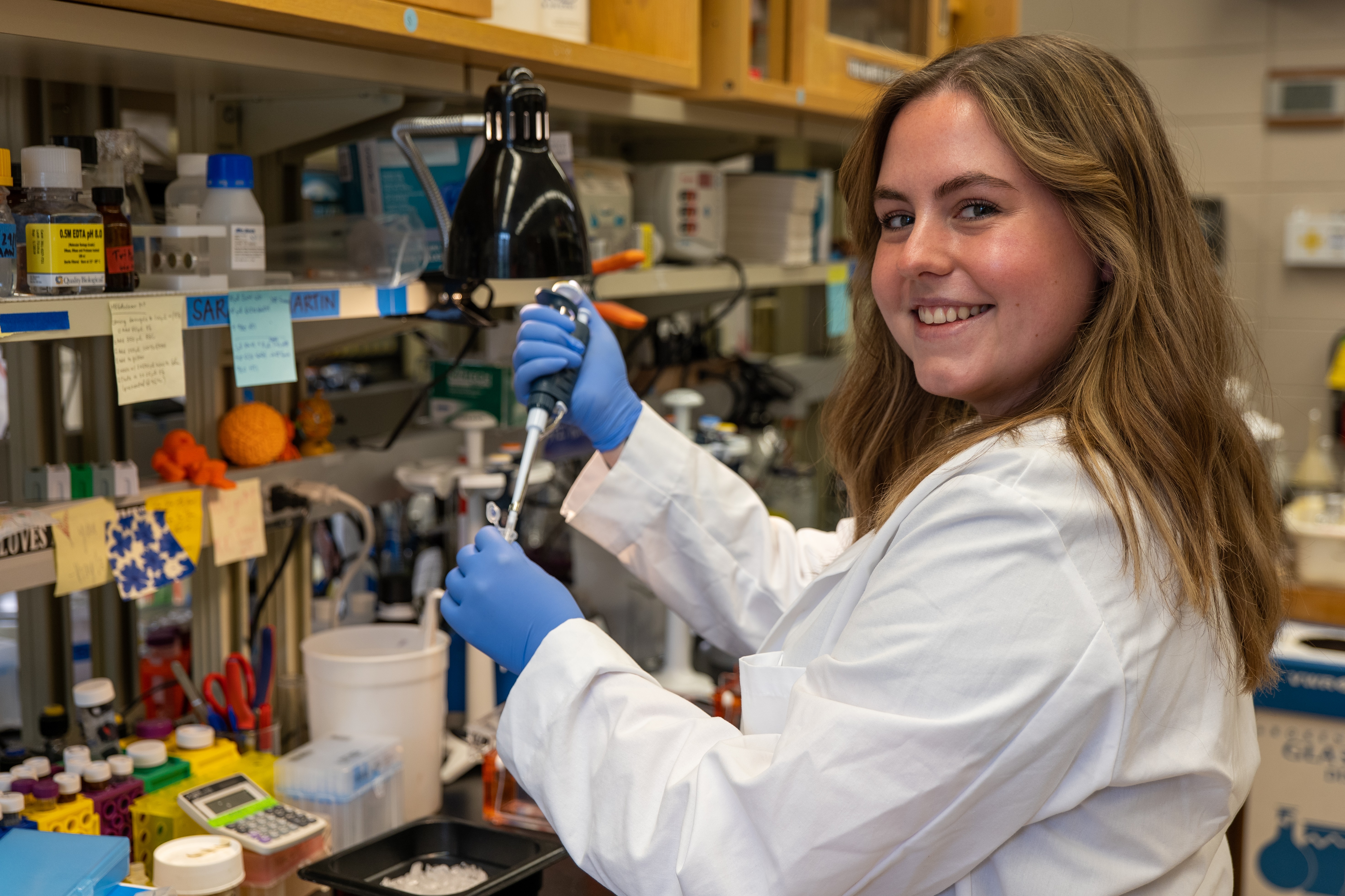 Sarah Martin using a pipette in the lab.