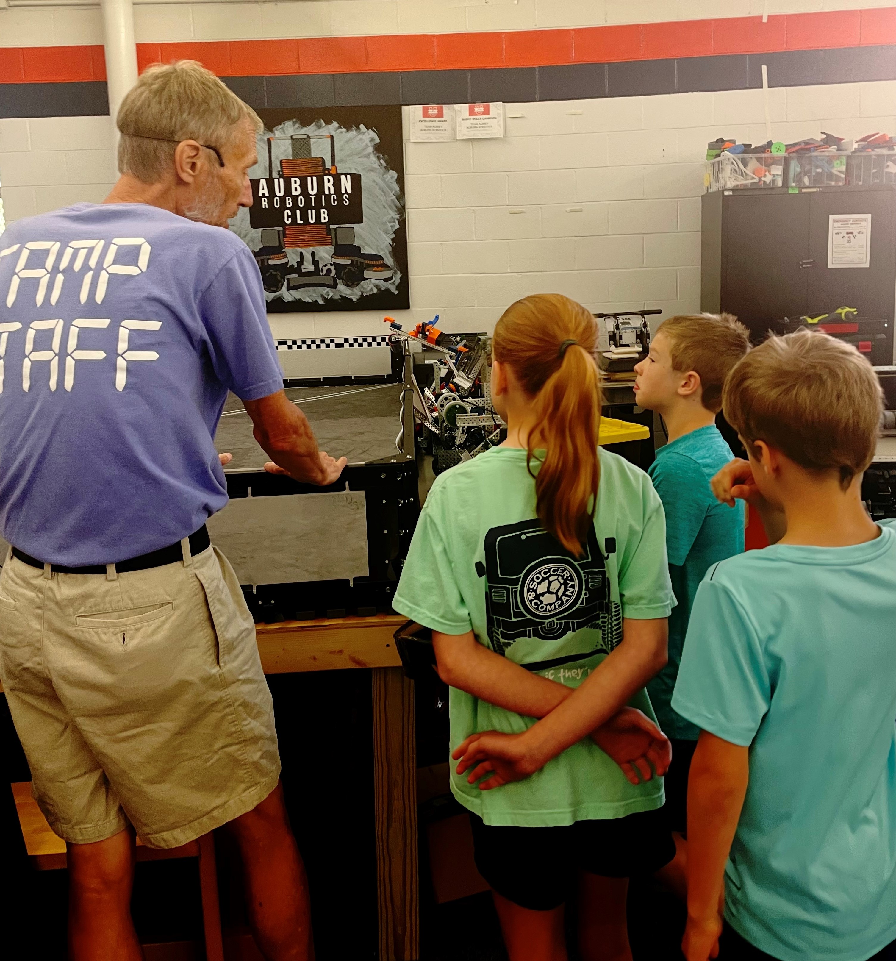 Lead instructor Bruce Zutter, who recently retired as an educator at Ogletree Elementary School, talks with VEX IQ campers about robotics.