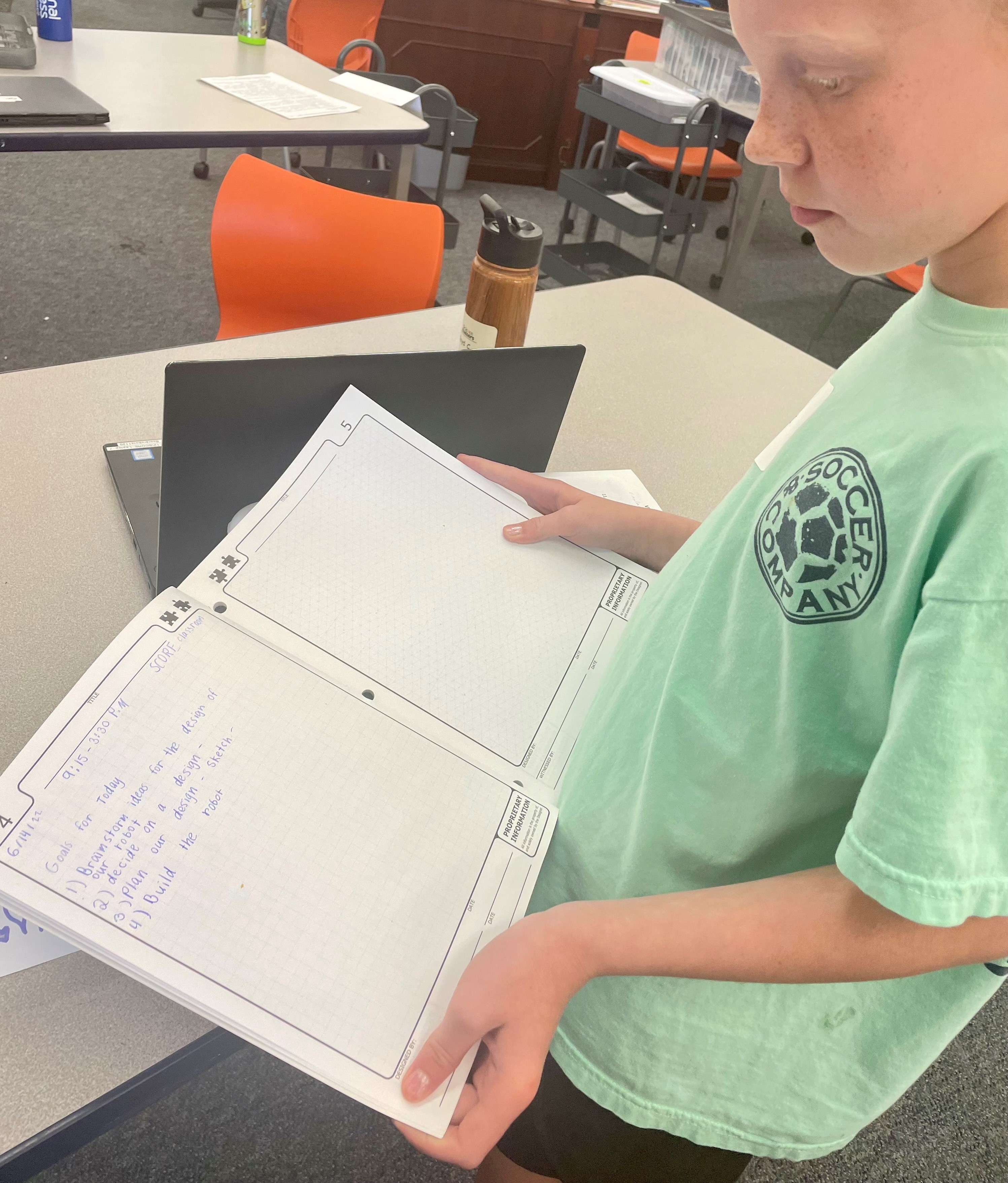 Allie Knight displays her goal setting engineering journal at VEX IQ Competition Camp.