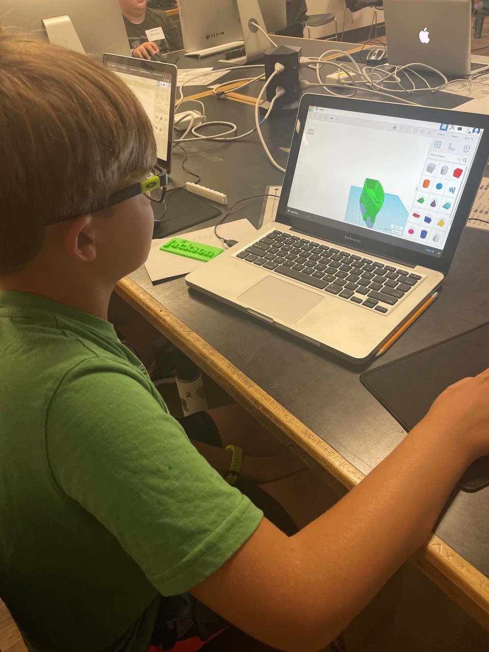 Jackson Jolly analyzes his boat design to decrease printing time at SCORE’s intermediate 3D printing and design camp.