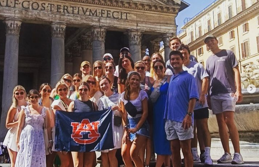 Auburn students in Italy with the Auburn flag