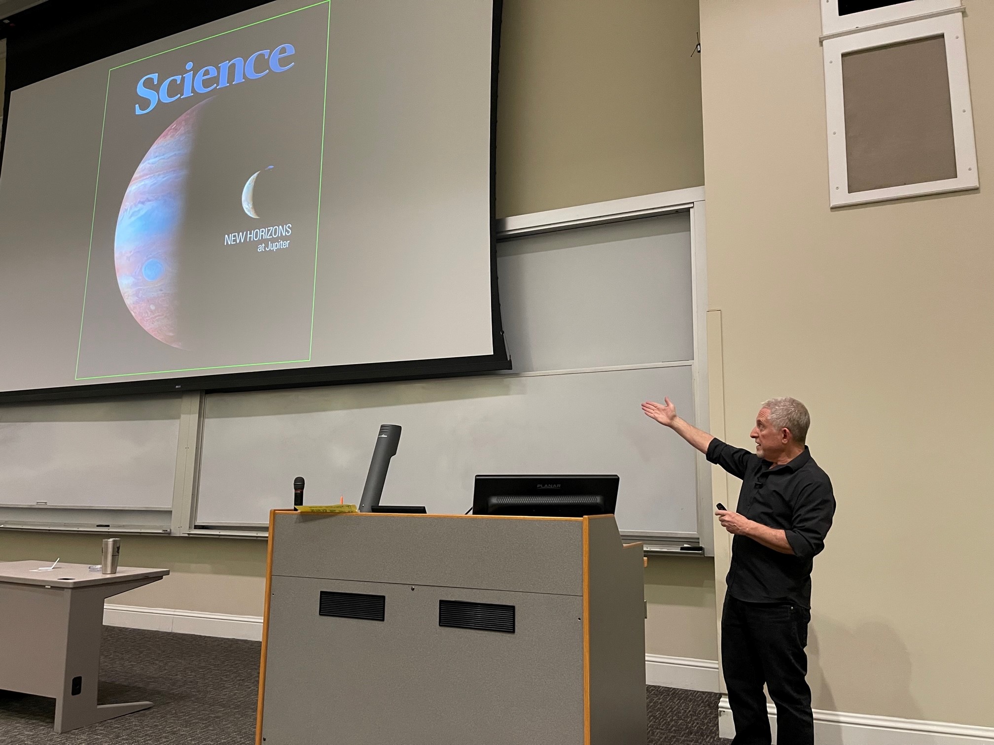Allan Stern points to the cover of Science that showed the extraordinary image of the New Horizons mission.