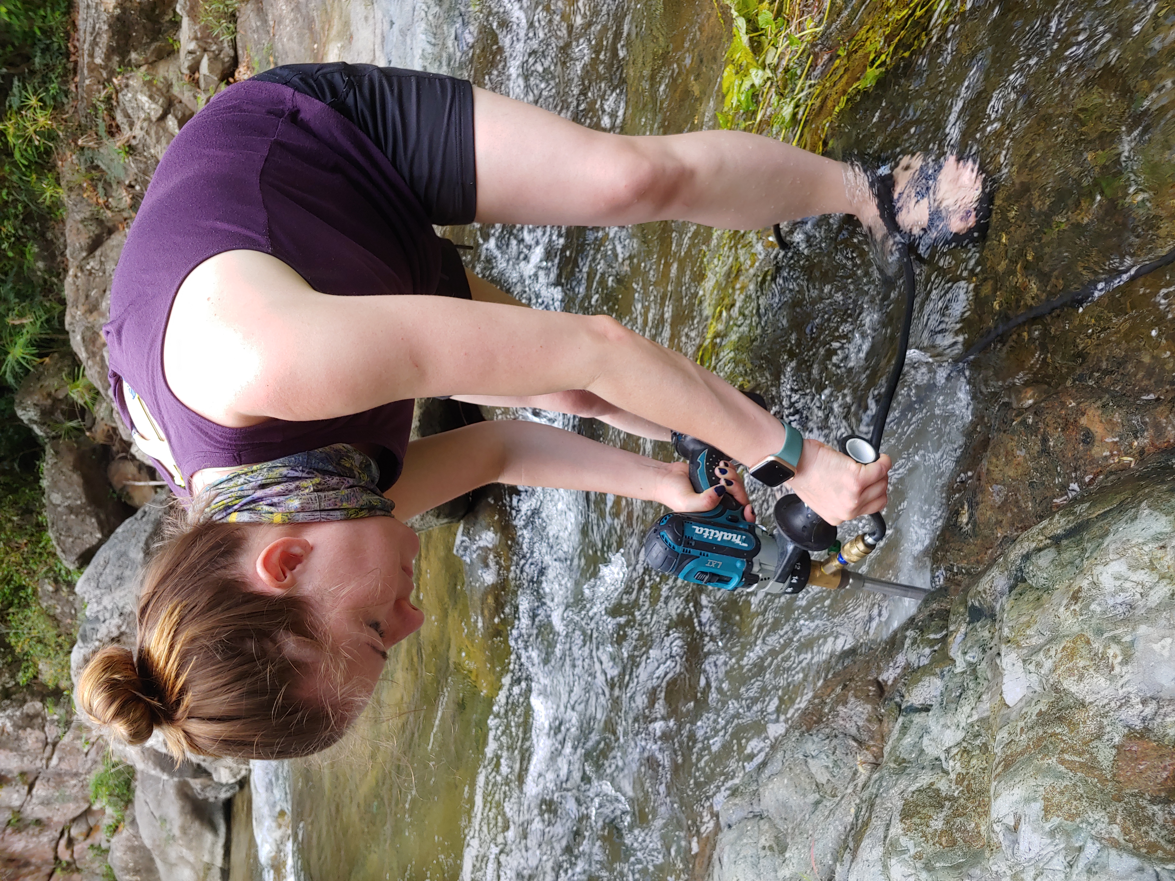 Laura Bilenker samples rocks at the Tibes iron deposit.