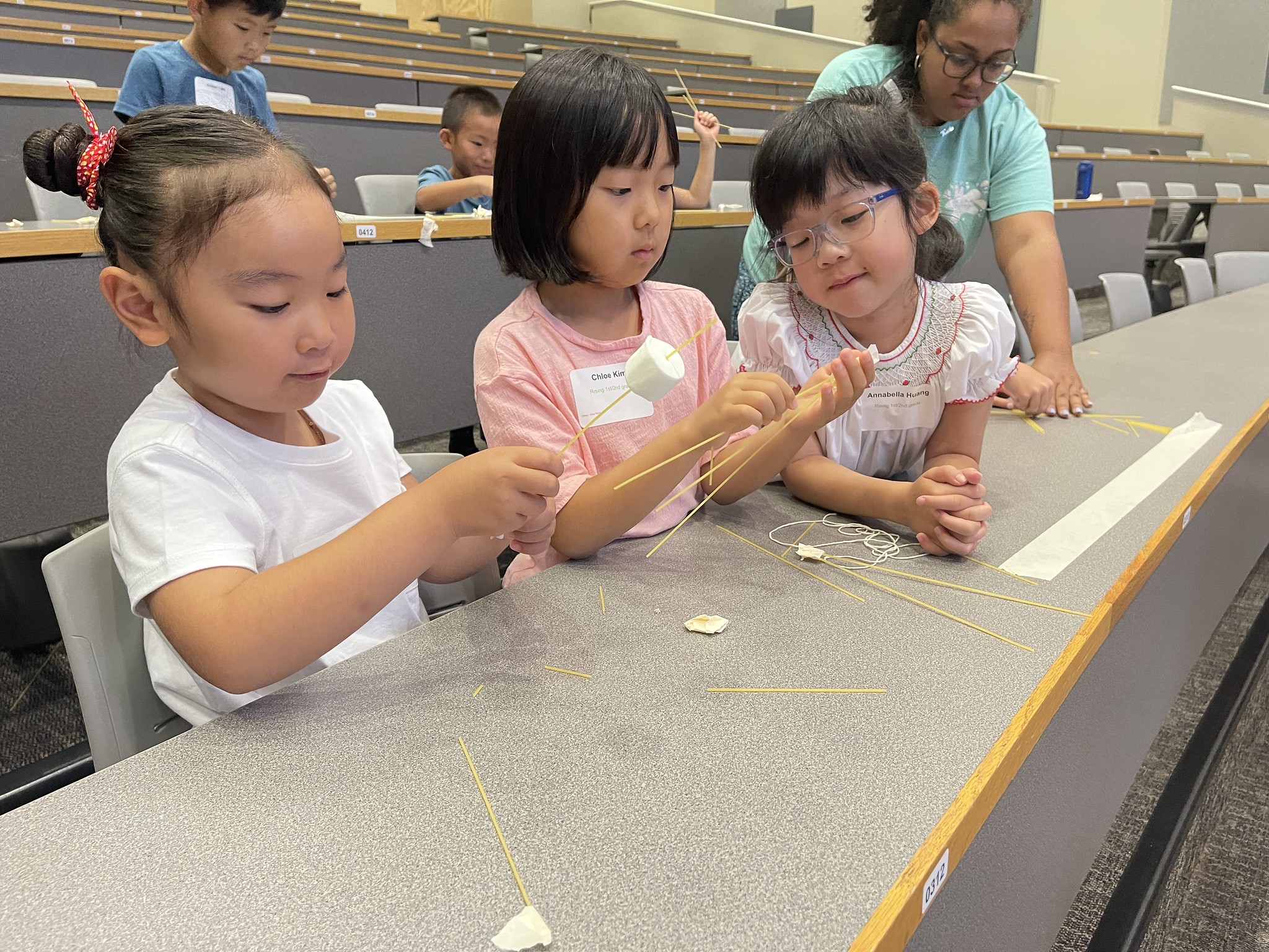 Science Matters participants compete to build the tallest pasta tower using the strength of triangles during math week.