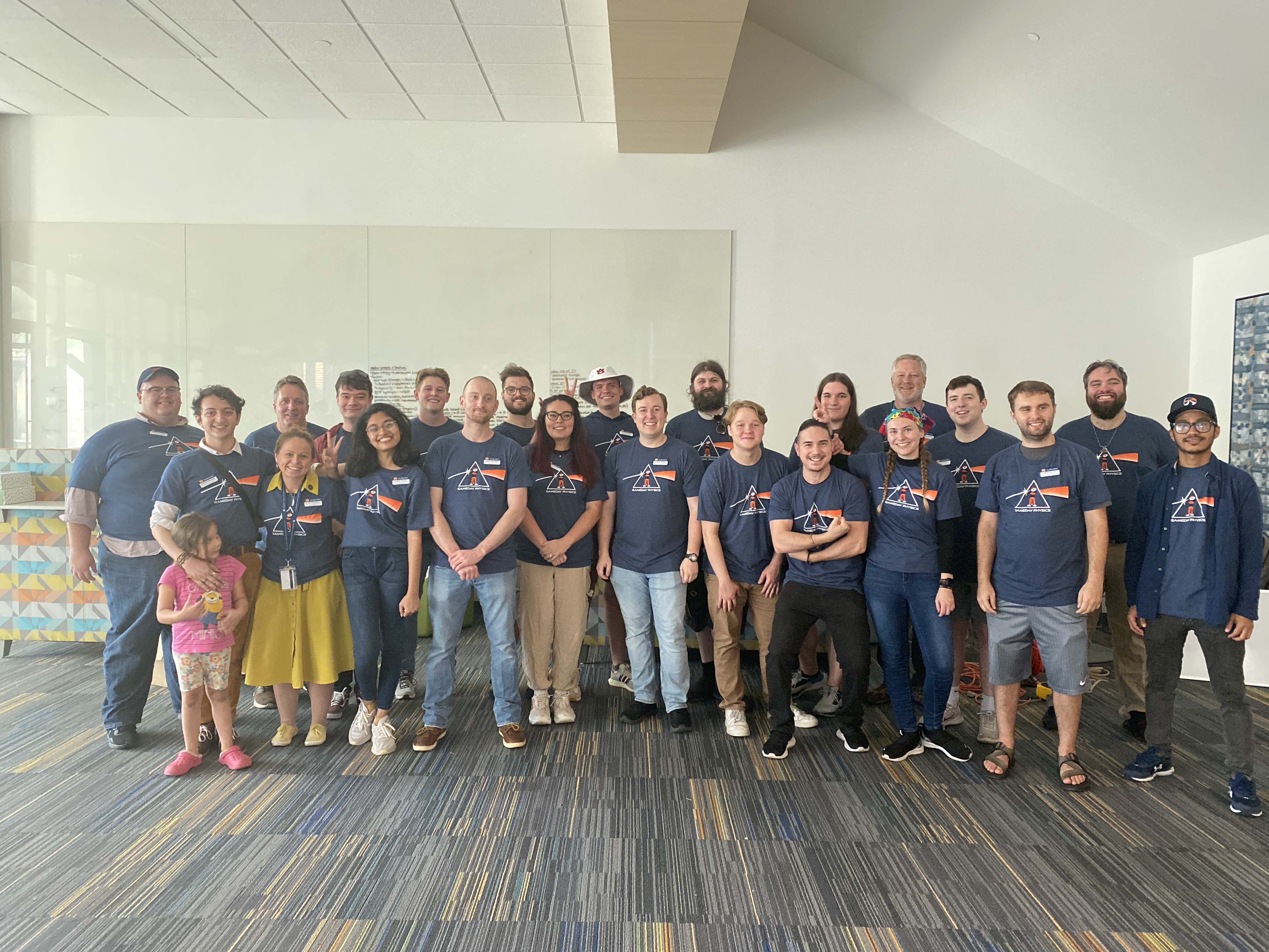 Physics department faculty and graduate students pose after a successful event.