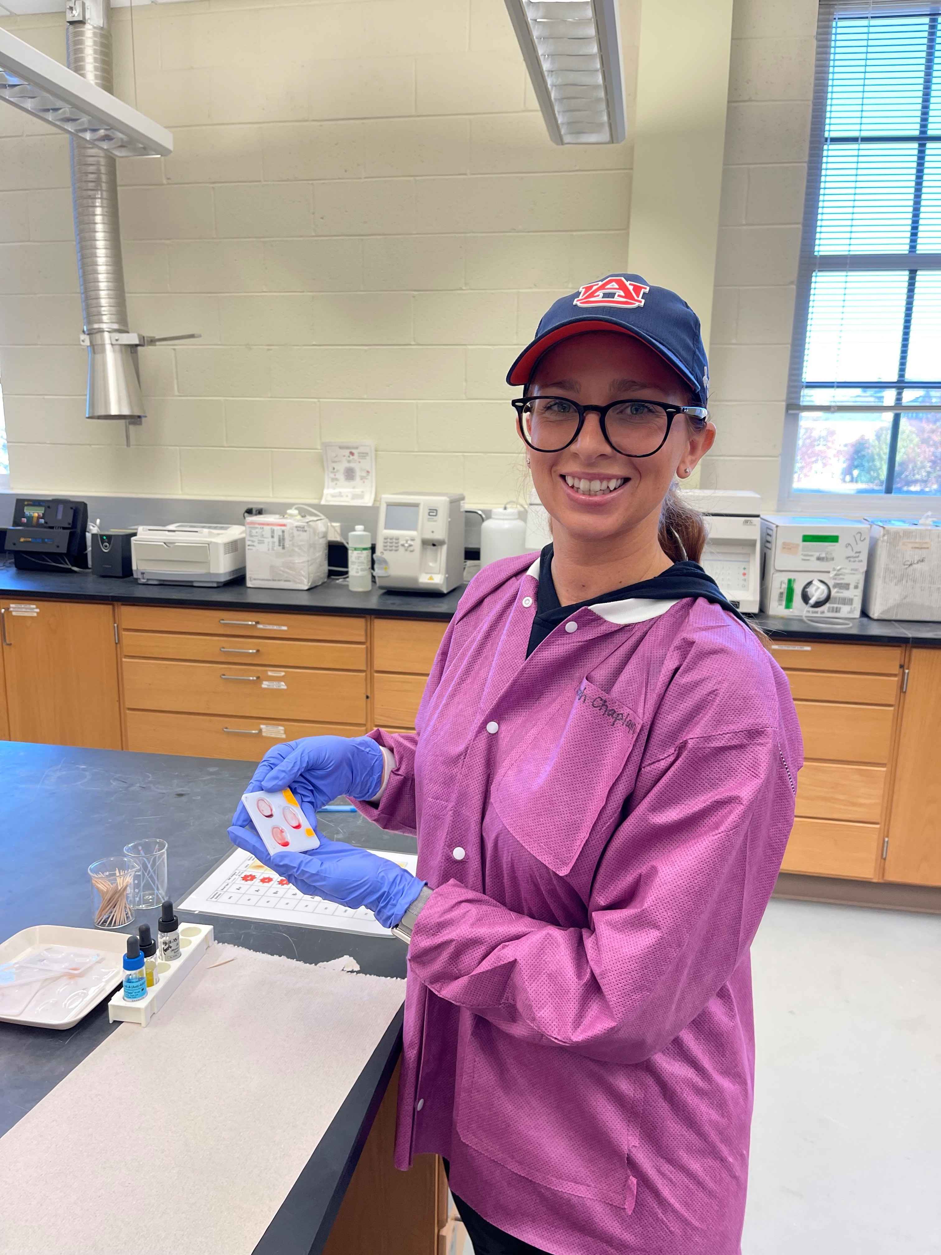 Sarah holding a blood type sample.