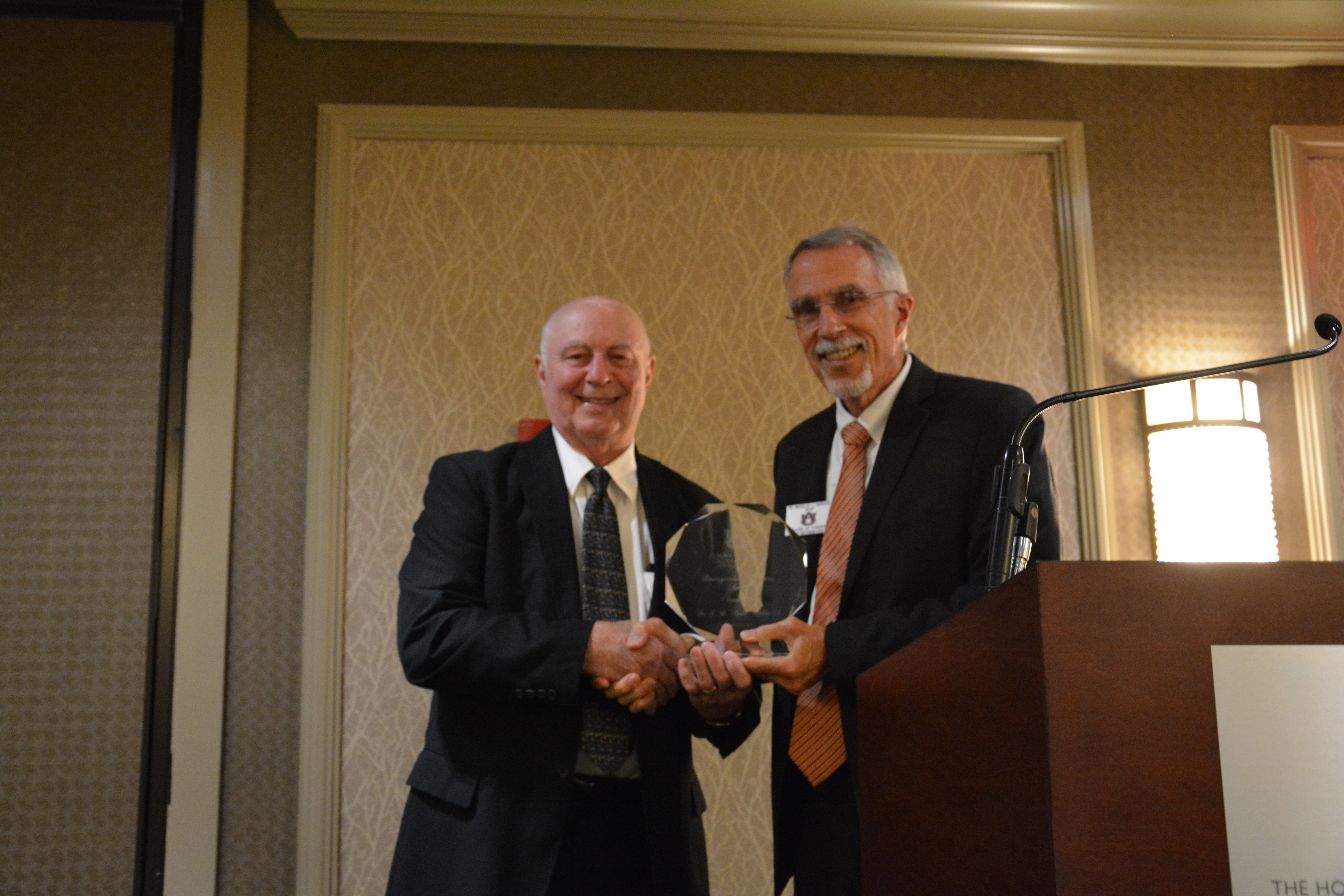 Dr. Worley receives the award from COSAM Dean Giordano. 