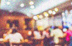 Grainy image of people sitting in classroom.