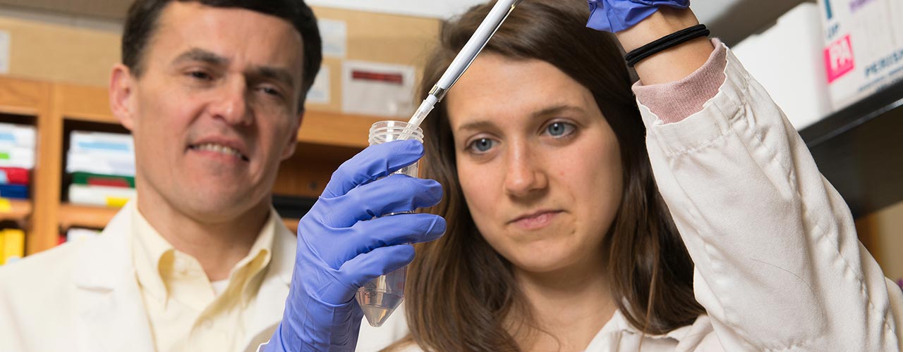 A group of students pose with a large check.