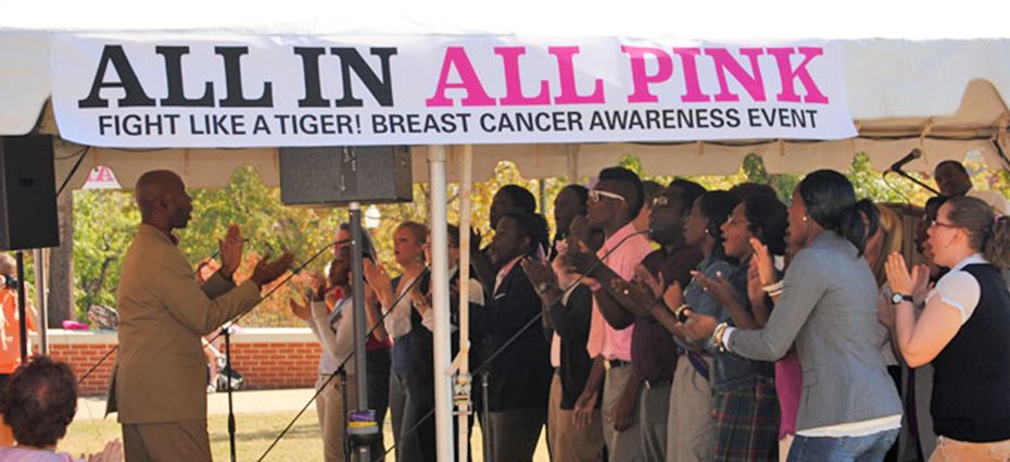 AU Choir sings and claps during all in all pink event.