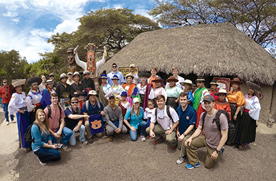 Class at Equator with costumed Ecuadorians.