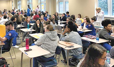 Students sit in desks in classroom