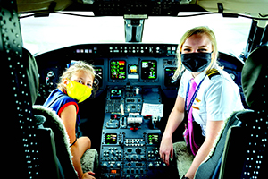 A young girl gets a tour of an Endeavor Air flight deck from the aircraft’s pilot.