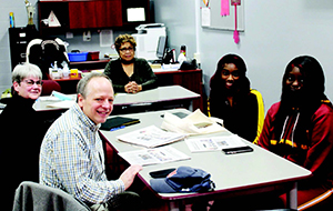 Journalism associate professor Nan Fairley and Mark Wilson, director for the Caroline Marshall Draughon Center for the Arts & Humanities, meet with interns Deliyah Johnson and ZaNaerial Marshall and Beatrice Legacy editor Mary Howard at J.F. Shields High School.