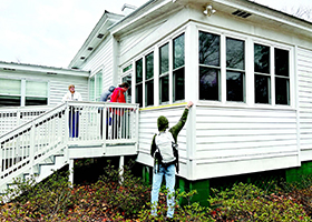 Students measure the back porch exterior of OLLI at Auburn’s home, Sunny Slope.