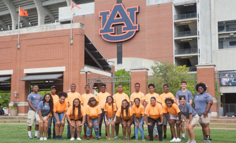 Group of campers poses for photo in front of AU football stadium.
