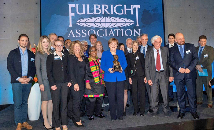 Fullbright scholars stand for group photo with award winner, Angela Merkel.