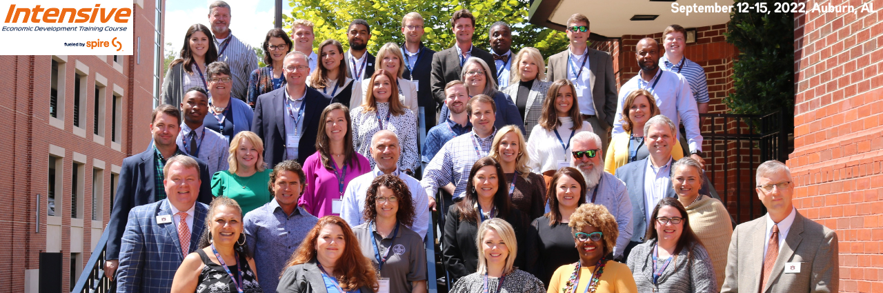 Image of program participants and text 'Intensive Economic Development Training Course fueled by Spire. September 12-15, 2022, Auburn, AL.