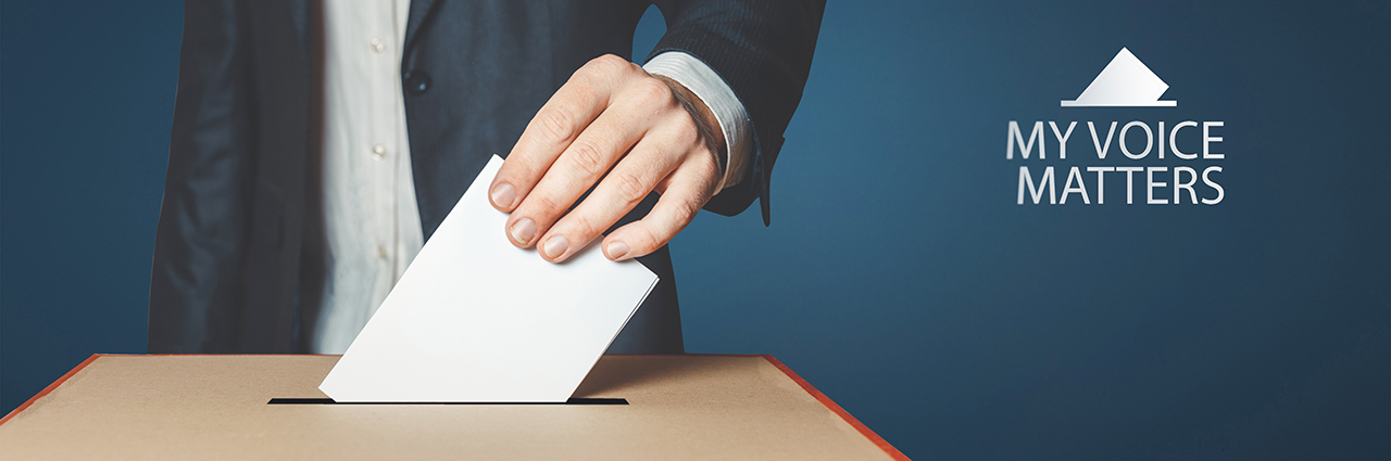 Man's hand shown dropping ballot in box with My Voice Matters text in right-hand corner of image