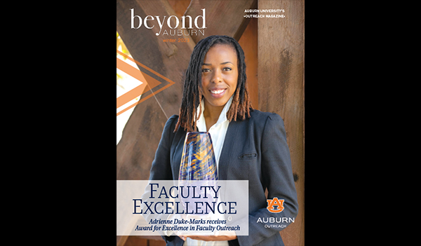 Cover of Beyond Auburn magazine Winter 2024 issue featuring Dr. Adrienne Duke-Marks holding her glass award