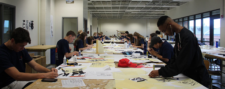 A shot of all of the students in Architecture Camp working on their drawings in the classroom.