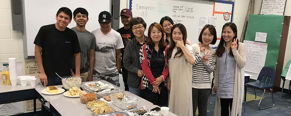 Summer English School students in the Adult Conversation Class enjoy spending time together as they eat food from all over the world.