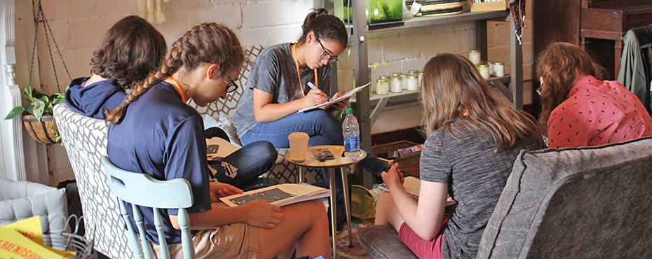 Group of students writing at a coffee shop