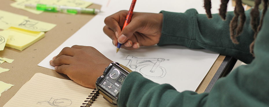 Student sketching a bicycle