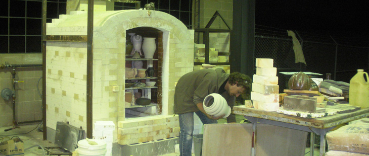 A Student works with his pottery creation