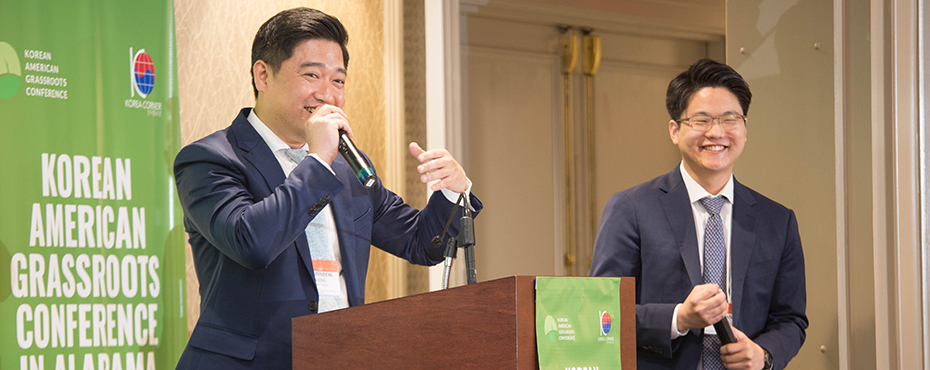Two speakers smile and laugh during presentation at Korean American Grassroots Conference.