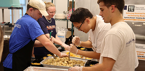 Auburn students, from left, Matt Tompson, Manie Castagneto, Michael Chen and Nick Martin work to package meals for The Campus Kitchen.