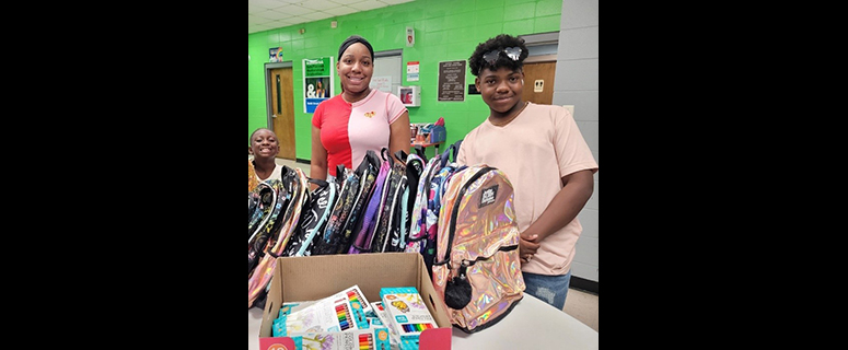 Volunteers and students of the Boys and Girls Club at a back-to-school event.