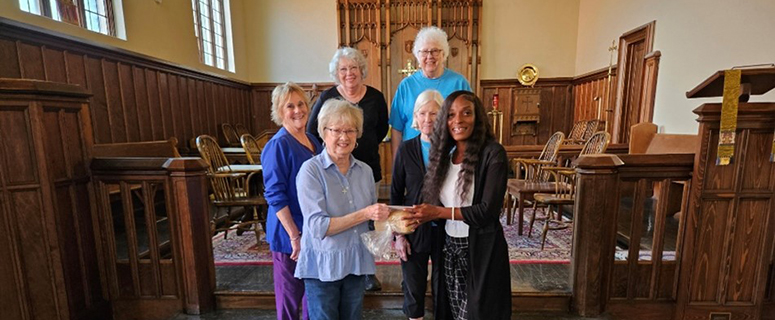 Executive Director, Zenene Humphrey, receiving a donation from St. Dunstan’s Episcopal Church.