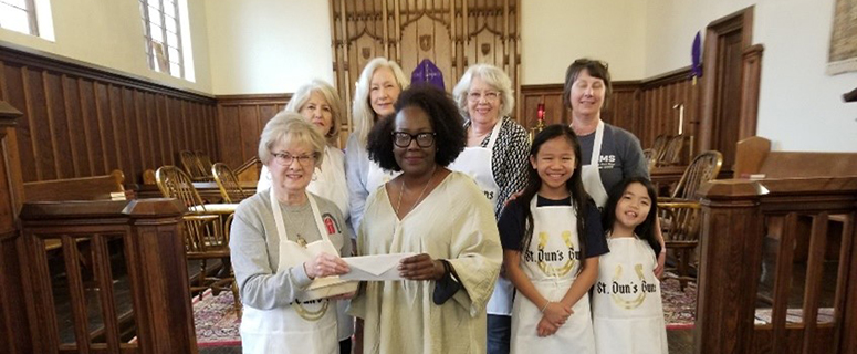 Executive Director, Patricia Butts, receiving a donation from St. Dunstan’s Episcopal Church.