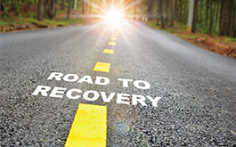 An open road with the text, 'Road to Recovery' written down the road