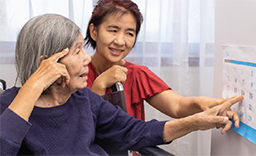 Two women pointing to the same date on a calendar