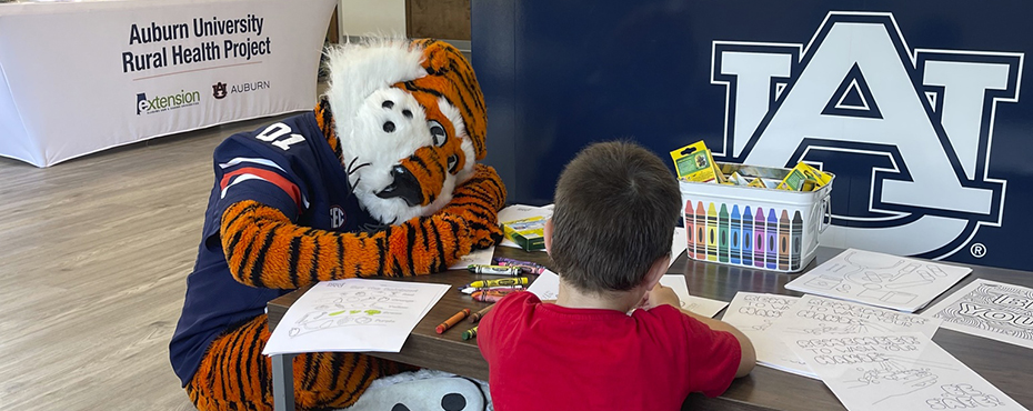 Aubie and kid drawing